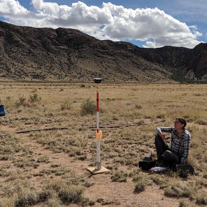 A researcher takes measurements on her phone from a high-resolution Emlid GPS base unit.